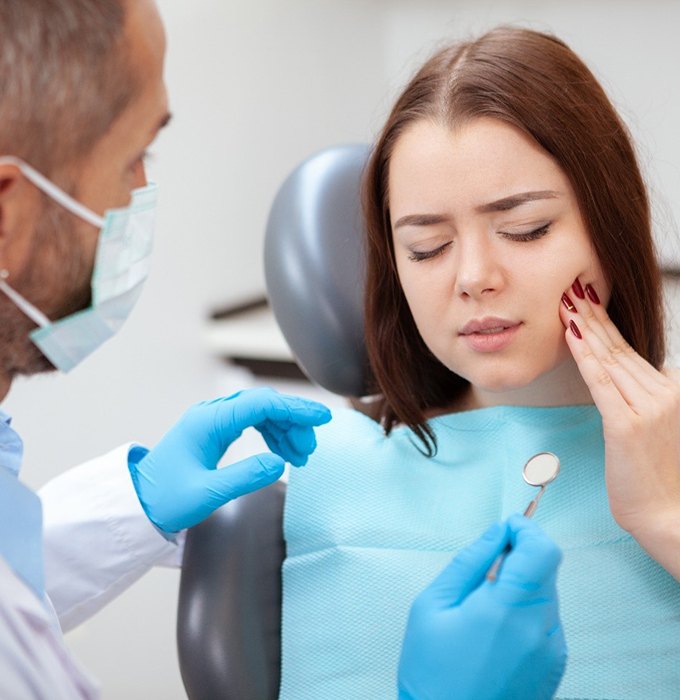 Woman visiting emergency dentist in Barton City for tooth pain