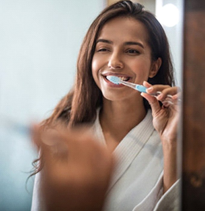 a person brushing their teeth at home