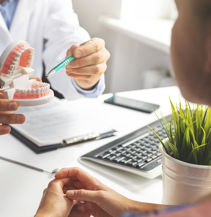 Dentist and patient discussing dental treatment plan