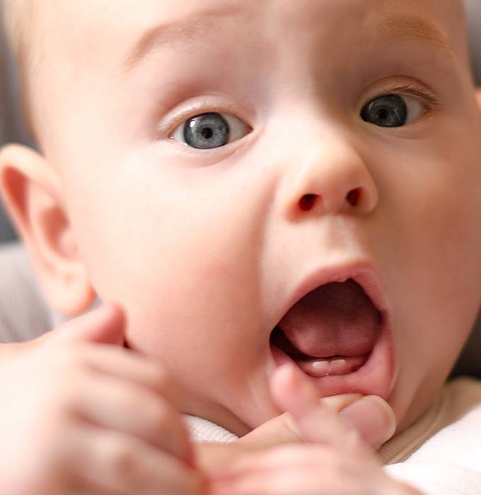 Dentist checking infant for lip and tongue tie