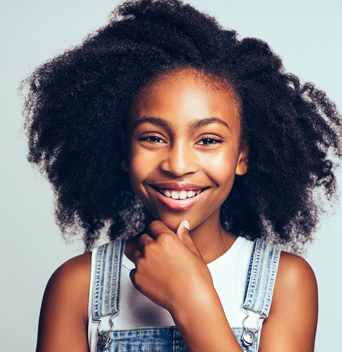 Young girl smiling after pulp therapy