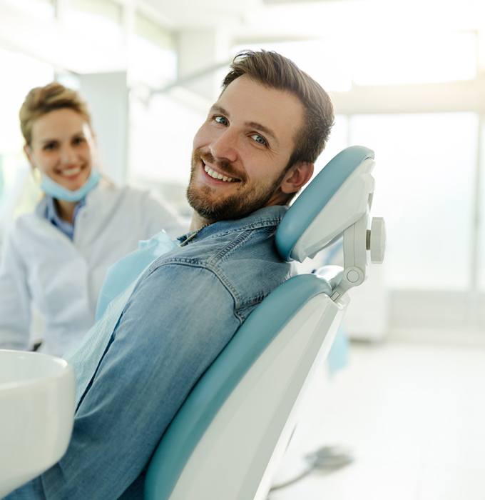 Happy dental patient in treatment chair