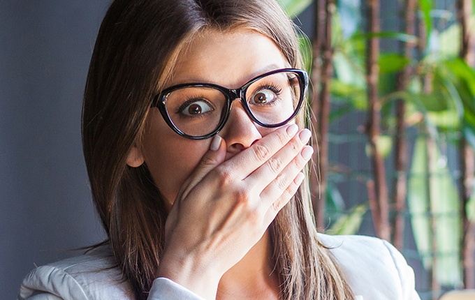 Woman with knocked out tooth covering mouth