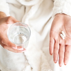 Patient holding pain medication for after dental implant surgery in Barton City