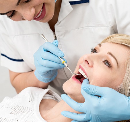 Woman receiving preventive dentistry exam