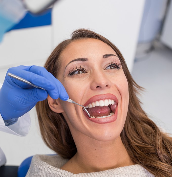 Woman receiving oral cancer screening