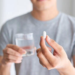 man about to take pill for oral conscious sedation
