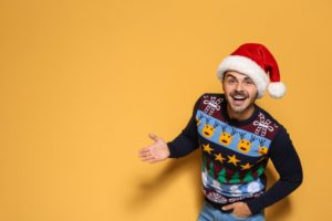 smiling man wearing santa hat